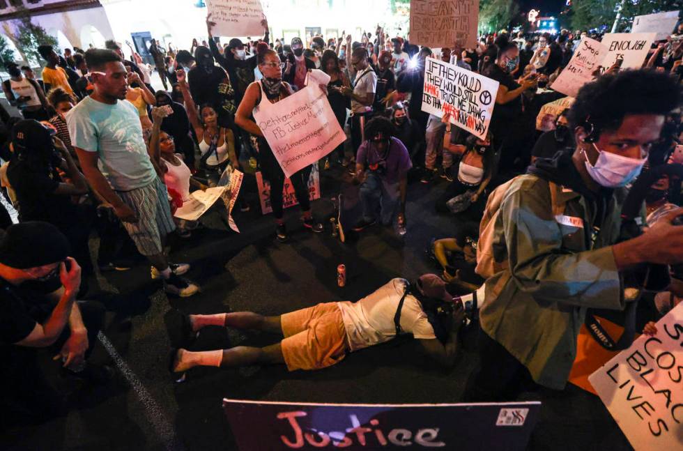 People protest the death of George Floyd in downtown Las Vegas on Saturday, May 30, 2020. (Chas ...