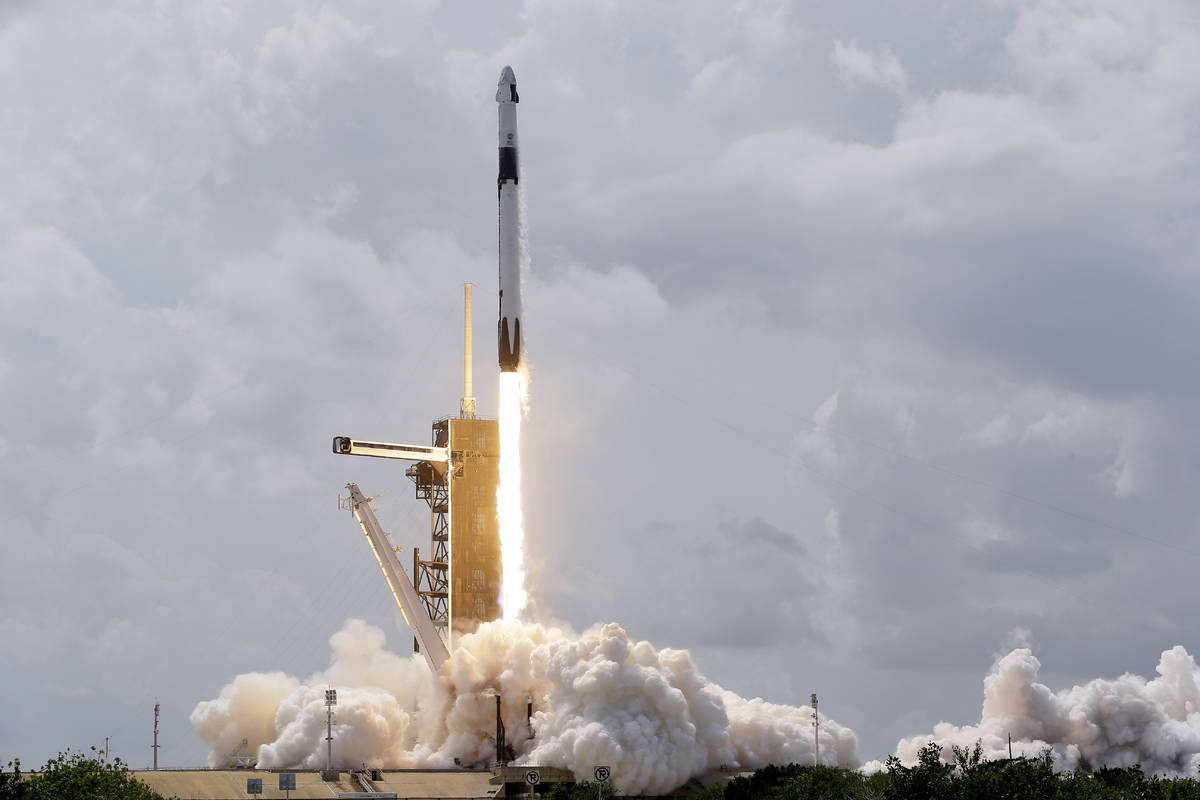 A SpaceX Falcon 9, with NASA astronauts Doug Hurley and Bob Behnken in the Crew Dragon capsule, ...