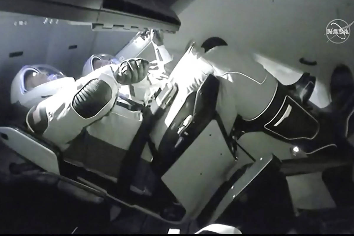 In this image taken from NASA TV video, the SpaceX Dragon crew capsule, with NASA astronauts Do ...