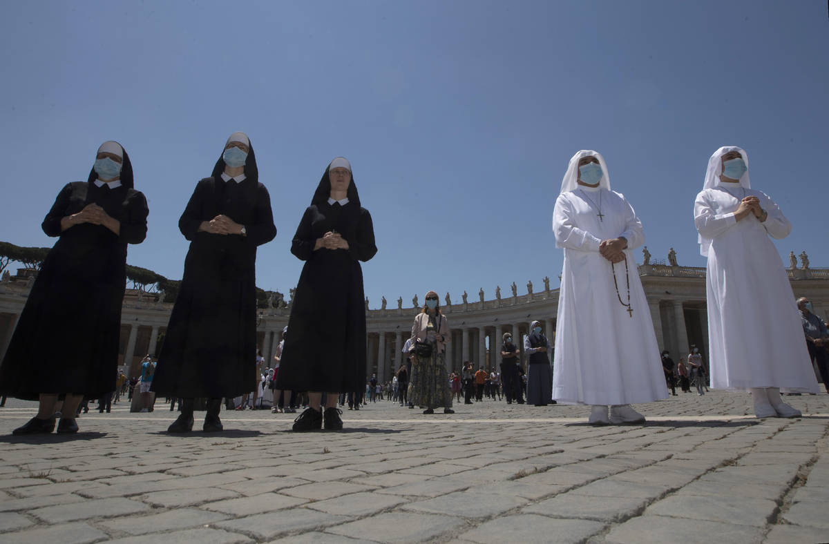 Nuns and faithful gather in St. Peter's Square at the Vatican, Sunday, May 31, 2020. Pope Franc ...