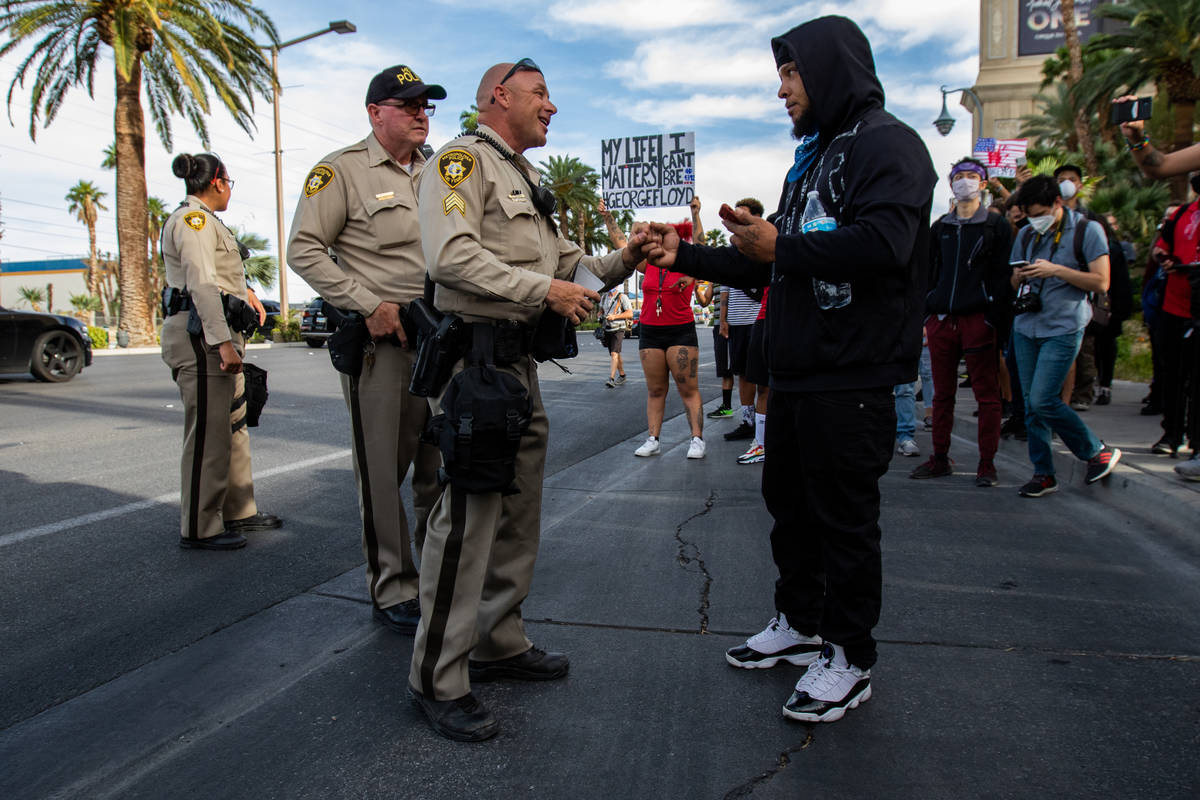 A demonstrator negotiates with police during a Black Lives Matter protest along the Strip on Su ...