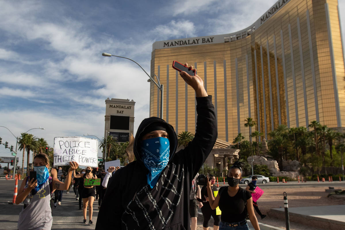 A demonstrator raises his hand during a Black Lives Matter protest along the Las Vegas Strip on ...