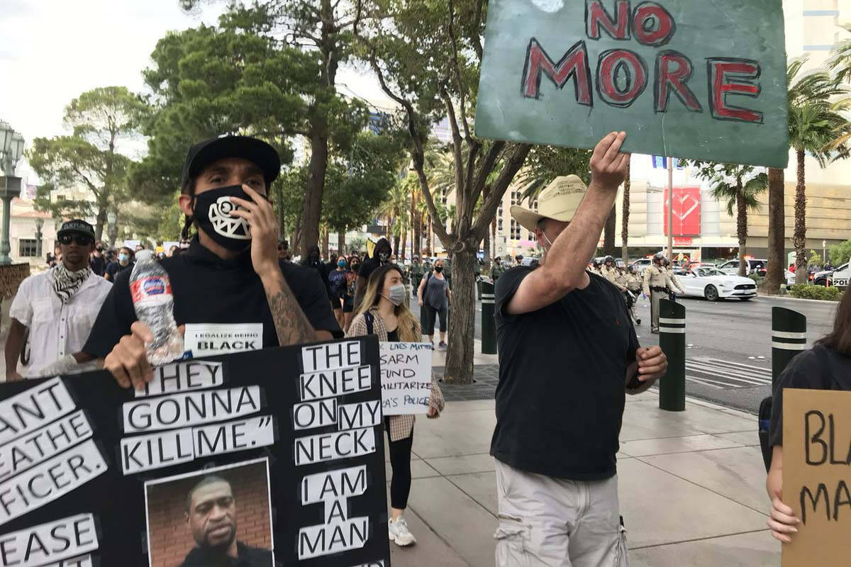 Garry Jones, left, takes part in the Black Lives Matter march on the Las Vegas Strip, Sunday, M ...