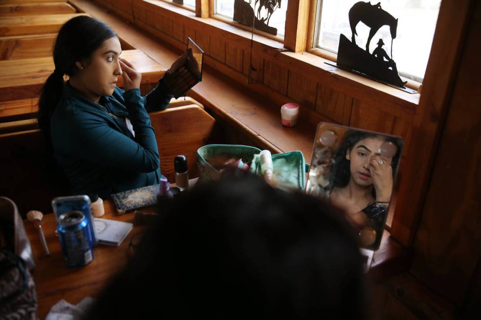 Linsy Enriquez, 16, left, and Melany Ortiz, 18, work on their make up as they prepare to perfor ...