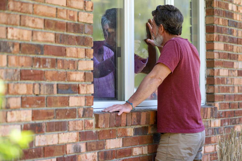 Jack Campise talks with his mother, Beverly Kearns, through her apartment window at the Kimberl ...