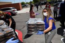 Comprehensive Cancer Centers of Nevada Connie Gutierrez, office manager, loads lunches donated ...