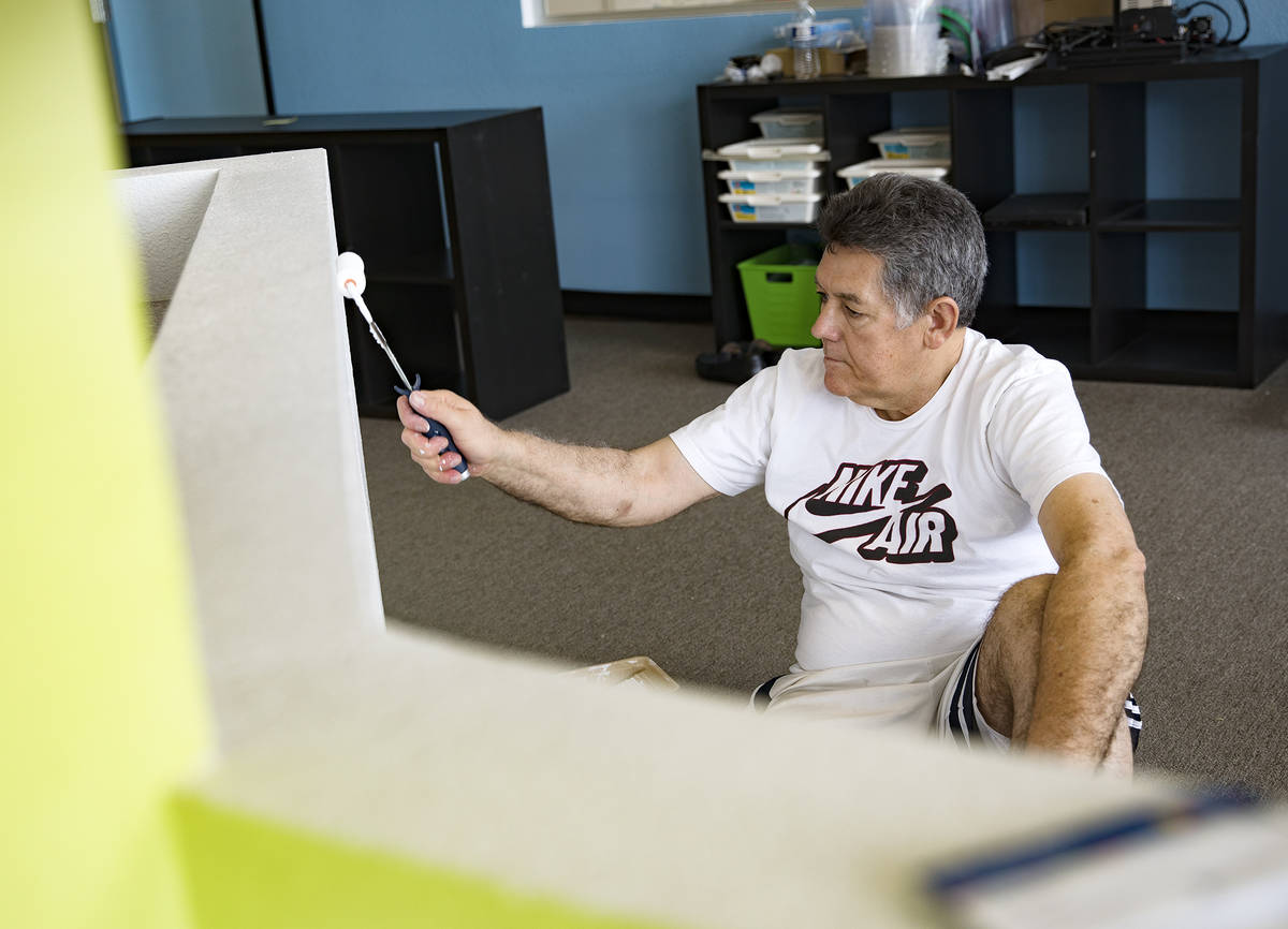 Hugo Silva, part owner of Engineering For Kids, repaints a wall at Engineering For Kids in Las ...