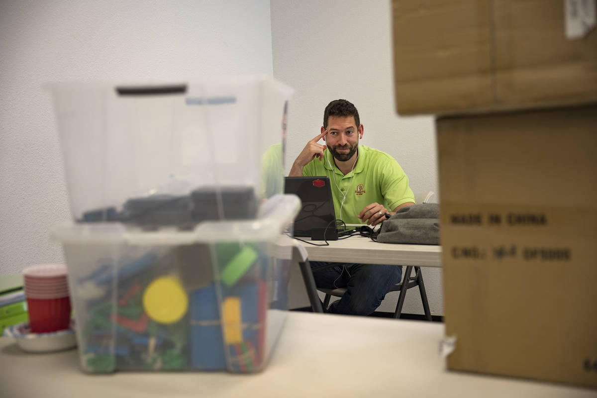 Leo Silva, part owner and teacher at Engineering For Kids, makes calls in preparation for reope ...