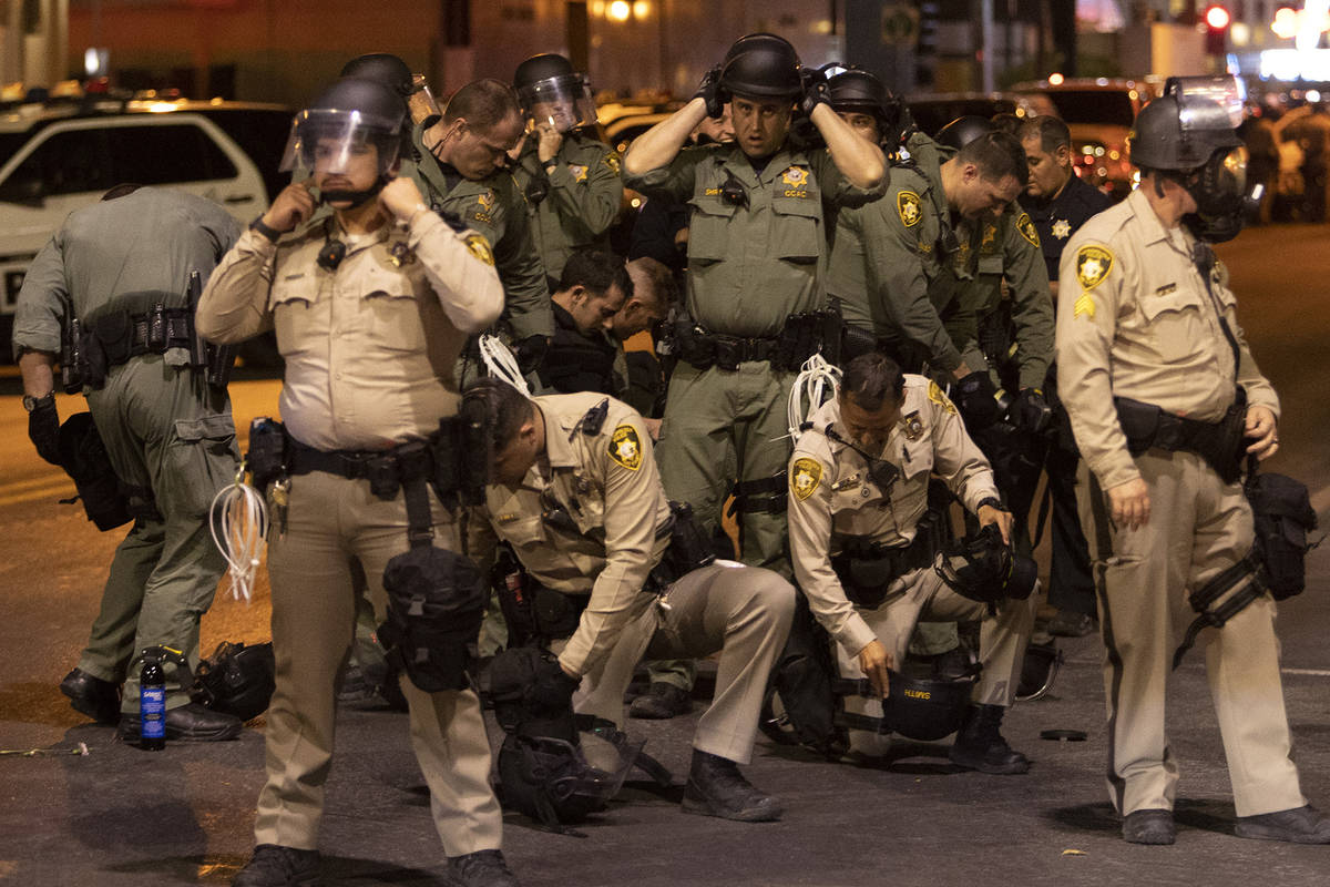 Metropolitan police put on riot gear during a protest in downtown on Monday, June 1, 2020 in La ...
