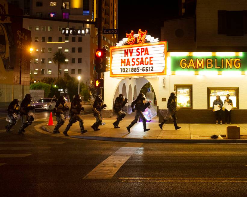 Police race down Fremont Street during a protest organized by Black Lives Matter in downtown La ...