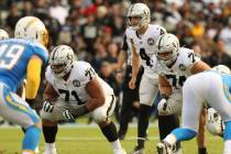 Oakland Raiders quarterback Derek Carr (4) readies himself on the line of scrimmage as offensiv ...