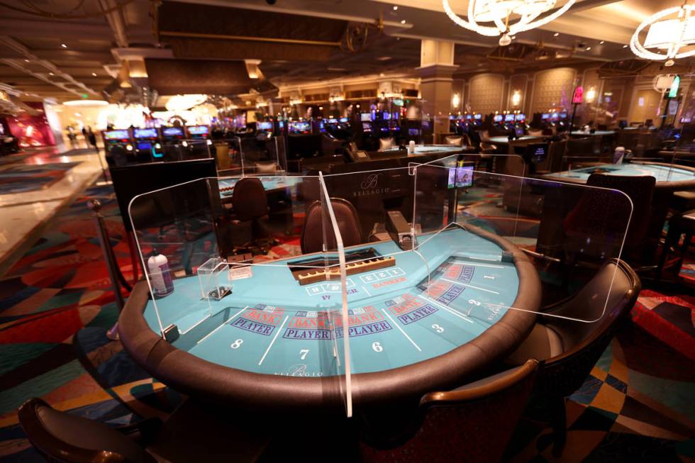 A baccarat table with plexiglass dividers at Bellagio during a media a tour showing "healt ...