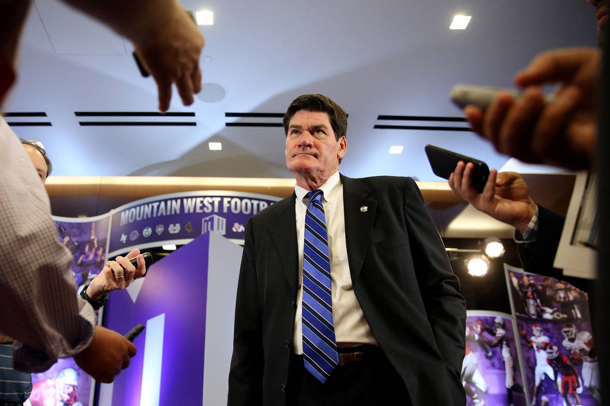 Commissioner Craig Thompson, center, is interviewed during the Mountain West Conference footbal ...