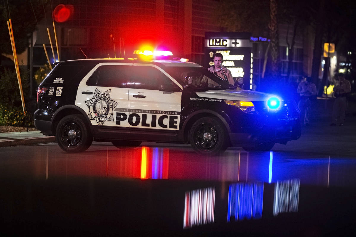 A group of Las Vegas police officers wait outside University Medical Center after an officer wa ...