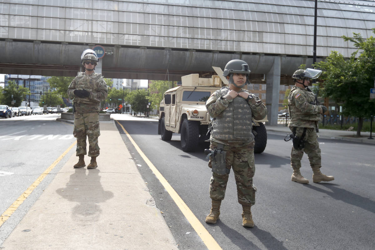 Members of an Illinois National Guard Military Police stand a post, Monday, June 1, 2020, at a ...