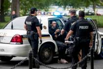 U.S. Secret Service police arrest a man for what one eye witness said an officer told him was f ...