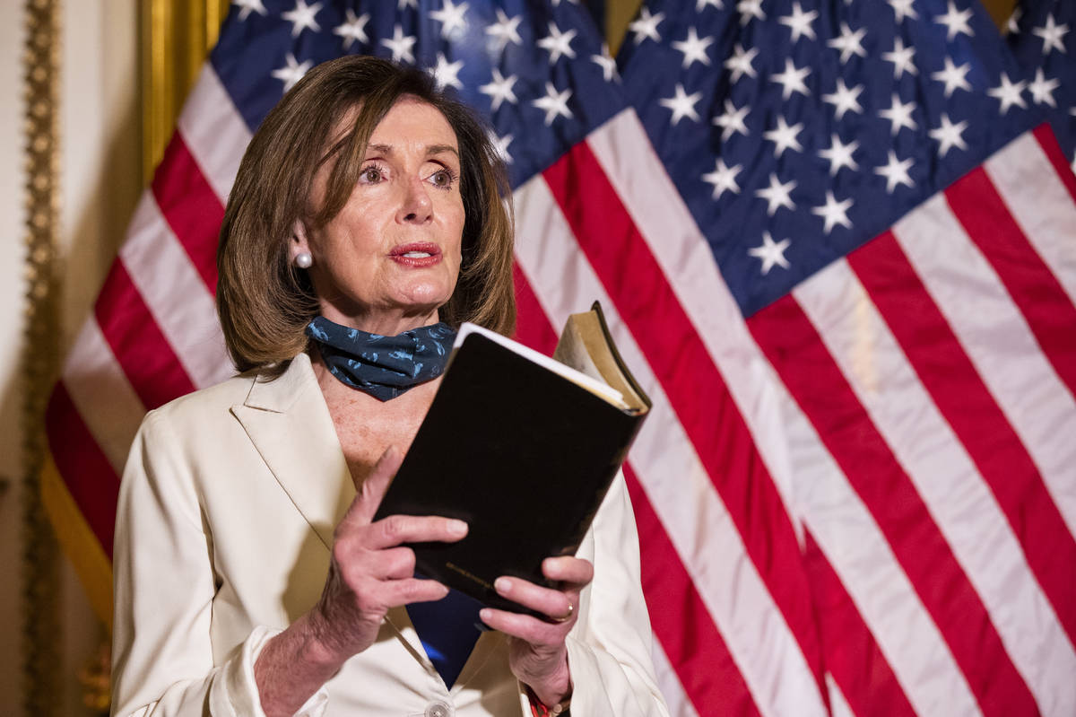 House Speaker Nancy Pelosi of Calif., reading from the Bible, reacts to President Donald Trump ...