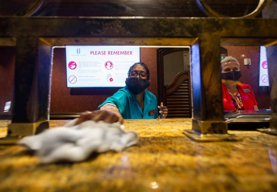 Kim Simpson, left, sanitizes the cage counter at TI on Thursday, June 4, 2020, in Las Vegas. (B ...