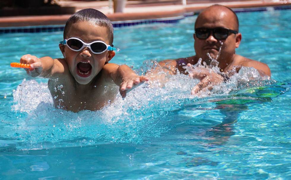 Sergio Gurrola Jr., 6, from Bakersfield, Calif., practices swimming with father Sergio Gurrola ...