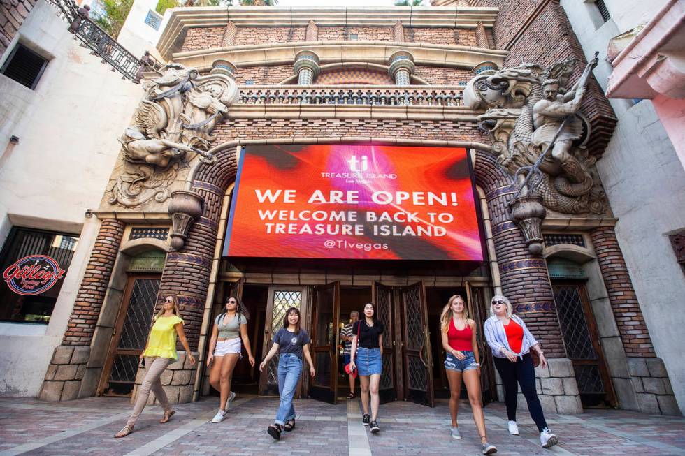 Guests walk under a large sign welcoming tourists back to TI on Thursday, June 4, 2020, in Las ...