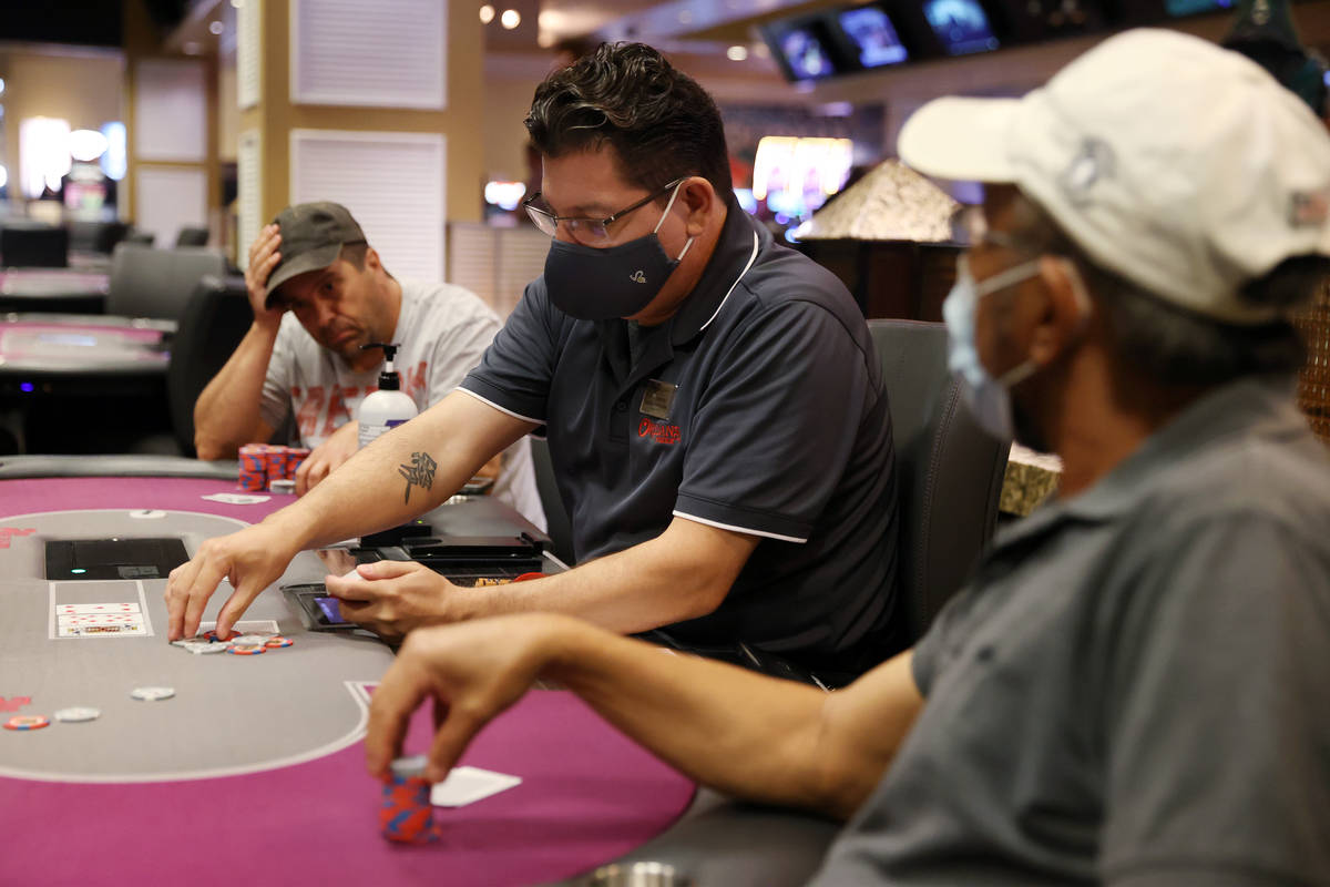 Dealer Adam Espinosa works a poker table during the first day after reopening at The Orleans ho ...