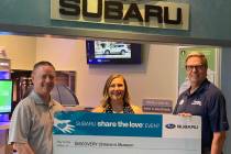 Caitlin Shea, director of development of the Discovery Children’s Museum, receives a check fo ...