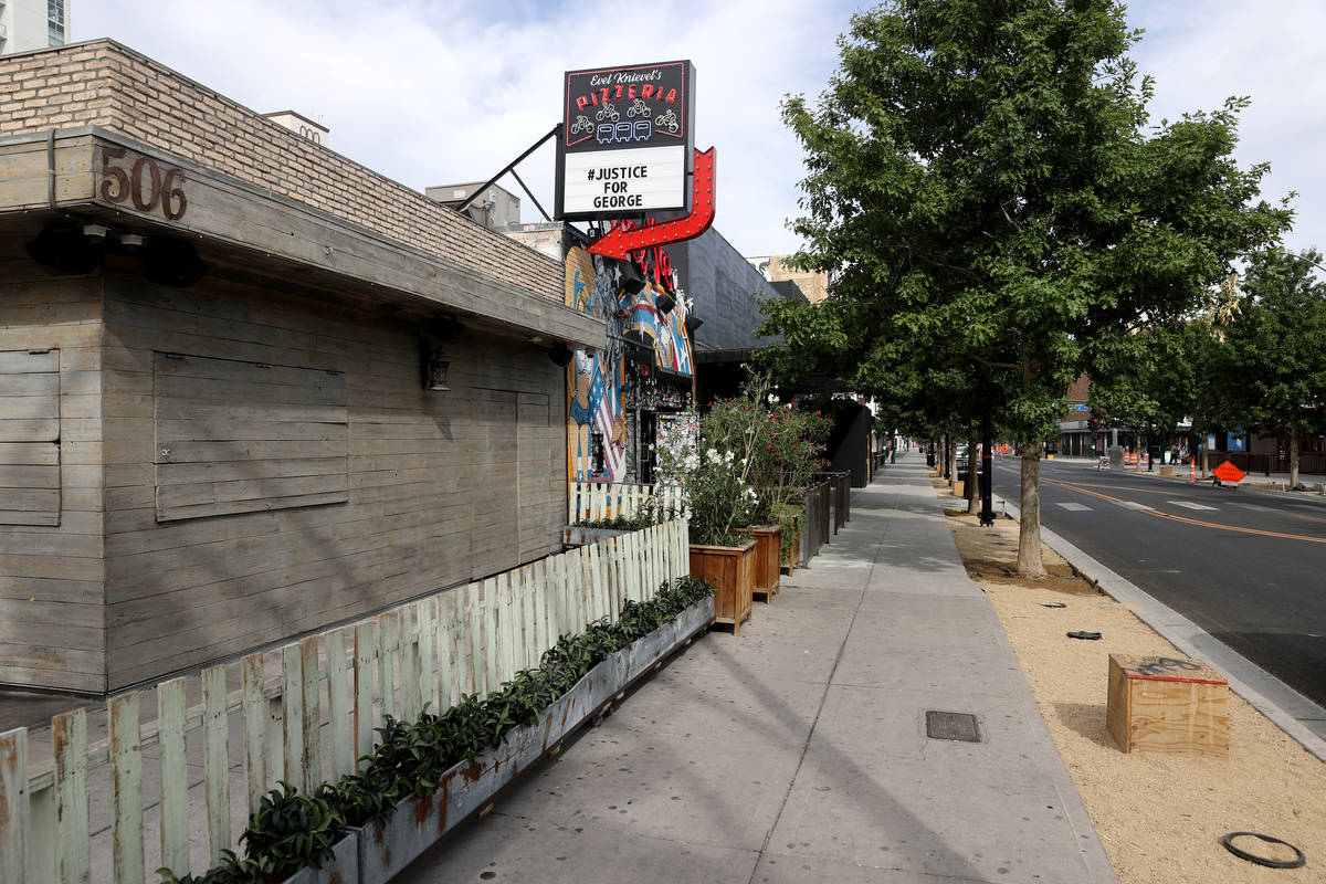 Park on Fremont, left, is boarded up and Evil Pie has a #JusticeForGeorge message on East Fremo ...