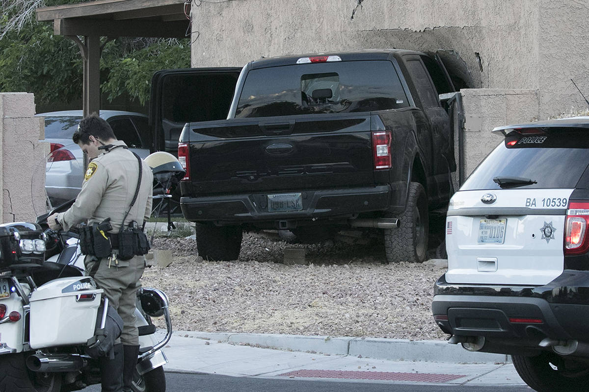 Las Vegas police investigate after a pickup crashed into a house at 401 North Torrey Pines Driv ...