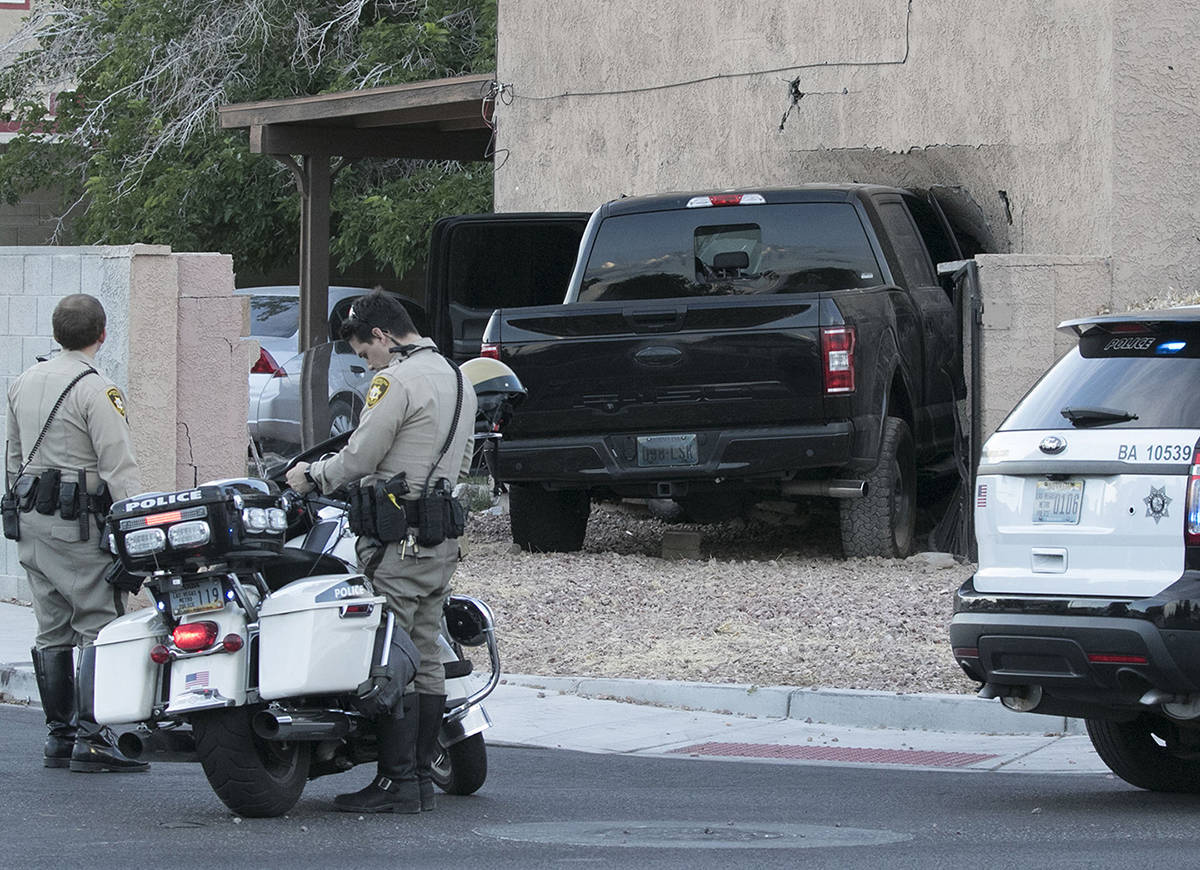 Las Vegas police investigate after a pickup crashed into a house at 401 North Torrey Pines Driv ...