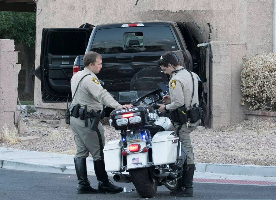 Las Vegas police investigate after a pickup crashed into a house at 401 North Torrey Pines Driv ...