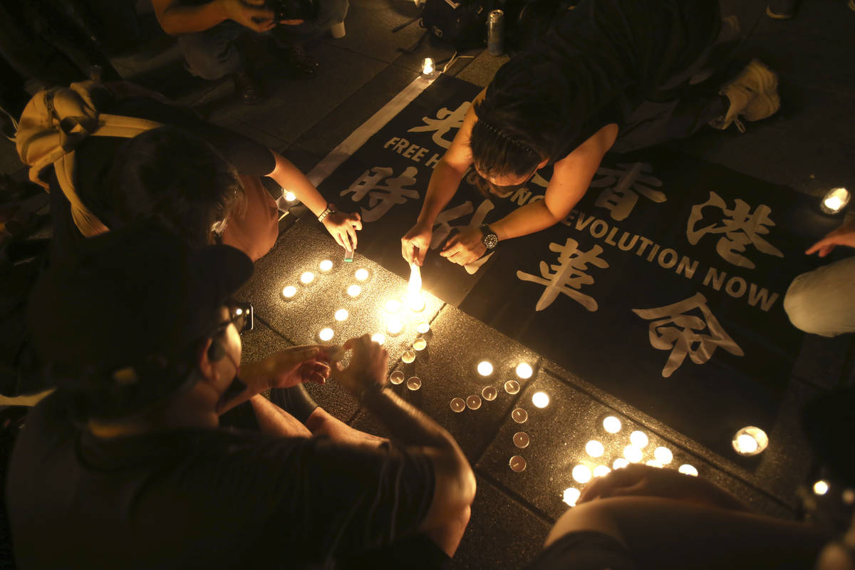 Hong Kong participants attend a candlelight vigil at Democracy Square in Taipei, Taiwan, Thursd ...