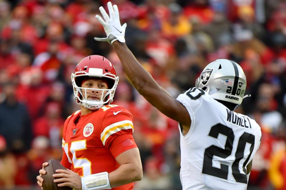 Kansas City Chiefs quarterback Patrick Mahomes (15) looks beyond Oakland Raiders cornerback Dar ...