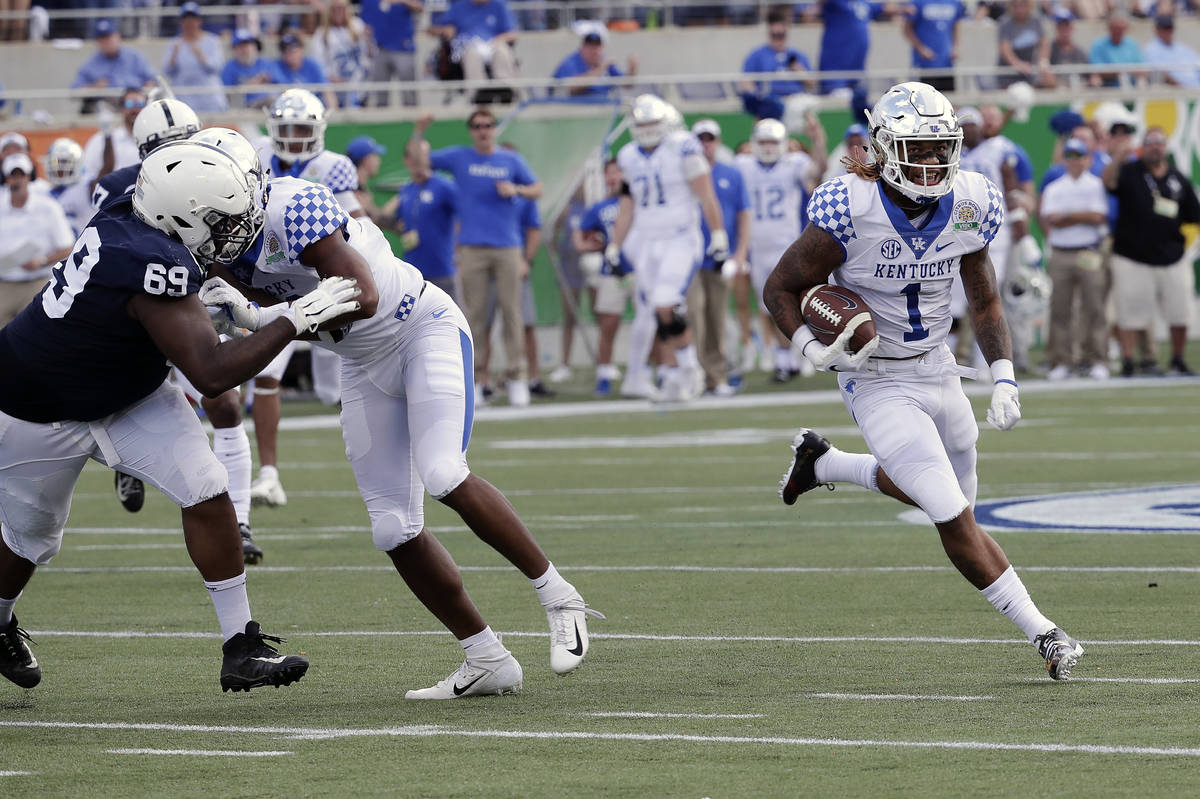 Kentucky's Lynn Bowden Jr. (1) returns a punt for a 58-yard touchdown as he gets past Penn Stat ...