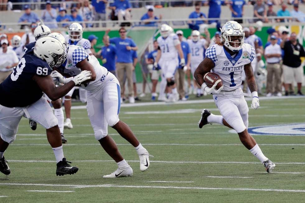 Kentucky's Lynn Bowden Jr. (1) returns a punt for a 58-yard touchdown as he gets past Penn Stat ...