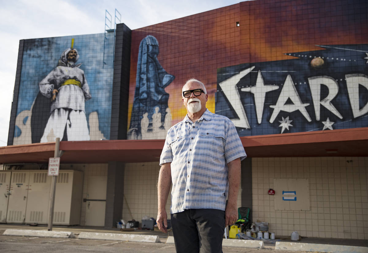 Artist James Stanford stands in front of his mural, “From the Land Beyond Beyond,&#x201d ...