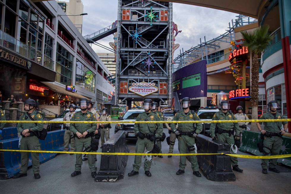 Police secure the Fremont Street Experience from protesters along Fremont Street during a Black ...