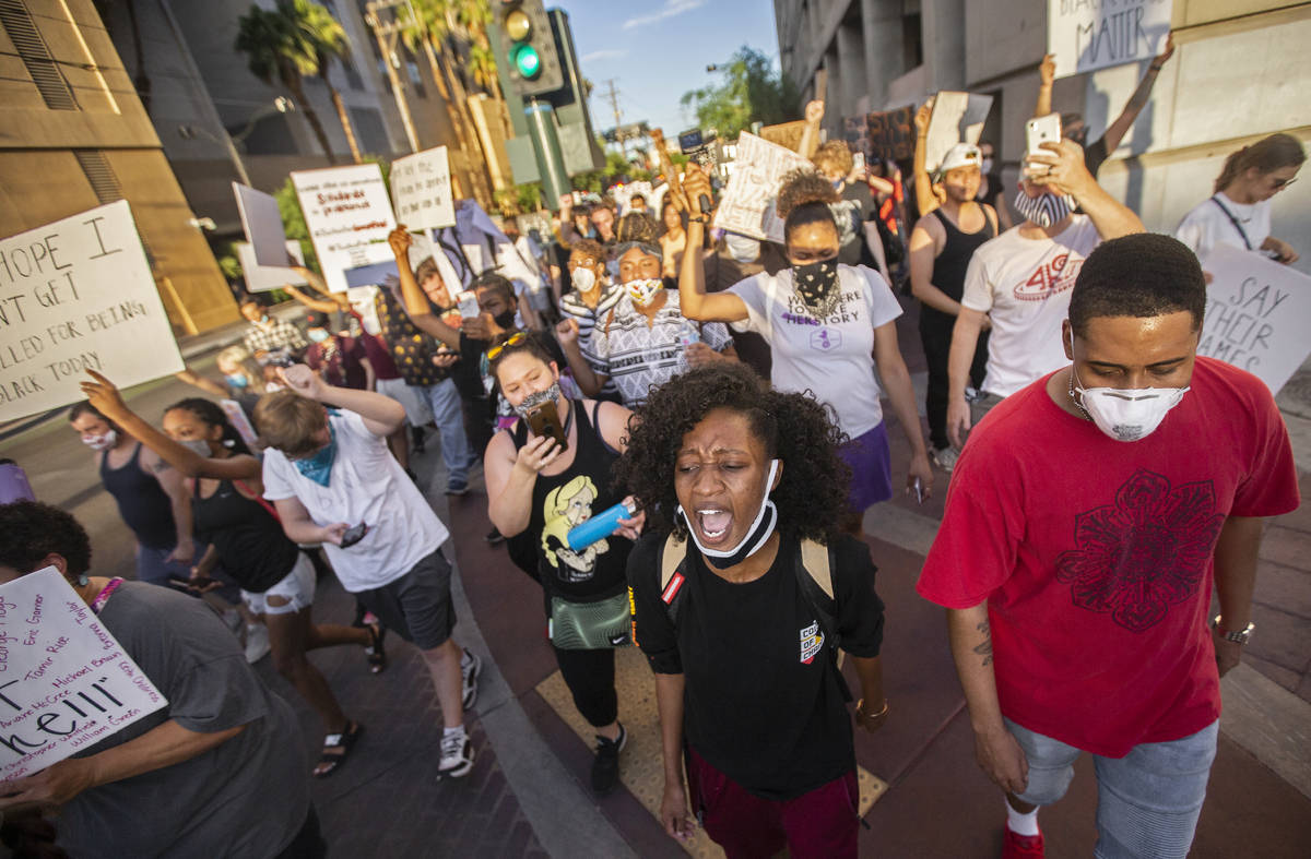 A crowd of at least 300 protesters march in downtown Las Vegas on Wednesday, June 3, 2020, as r ...