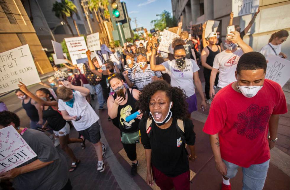 A crowd of at least 300 protesters march in downtown Las Vegas on Wednesday, June 3, 2020, as p ...