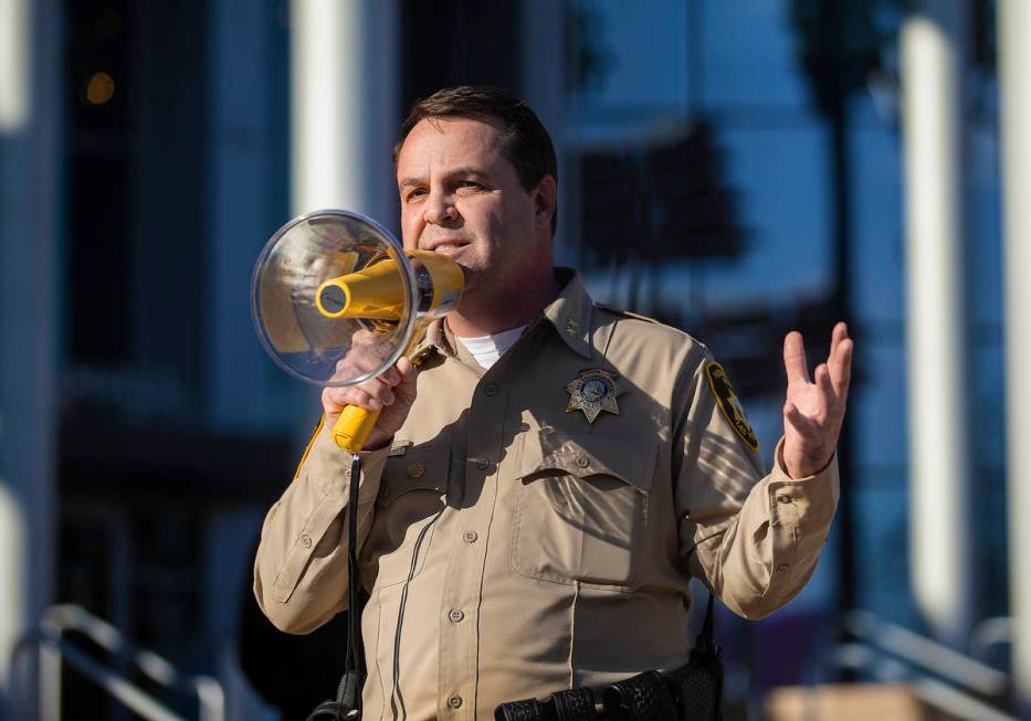 Assistant sheriff Christopher Jones addresses a crowd of at least 300 protesters outside Las Ve ...