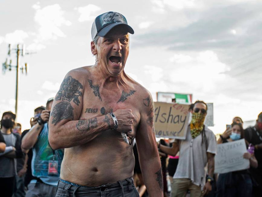 An agitated man screaming "my life matters" walks through hundreds of protesters outside Las Ve ...