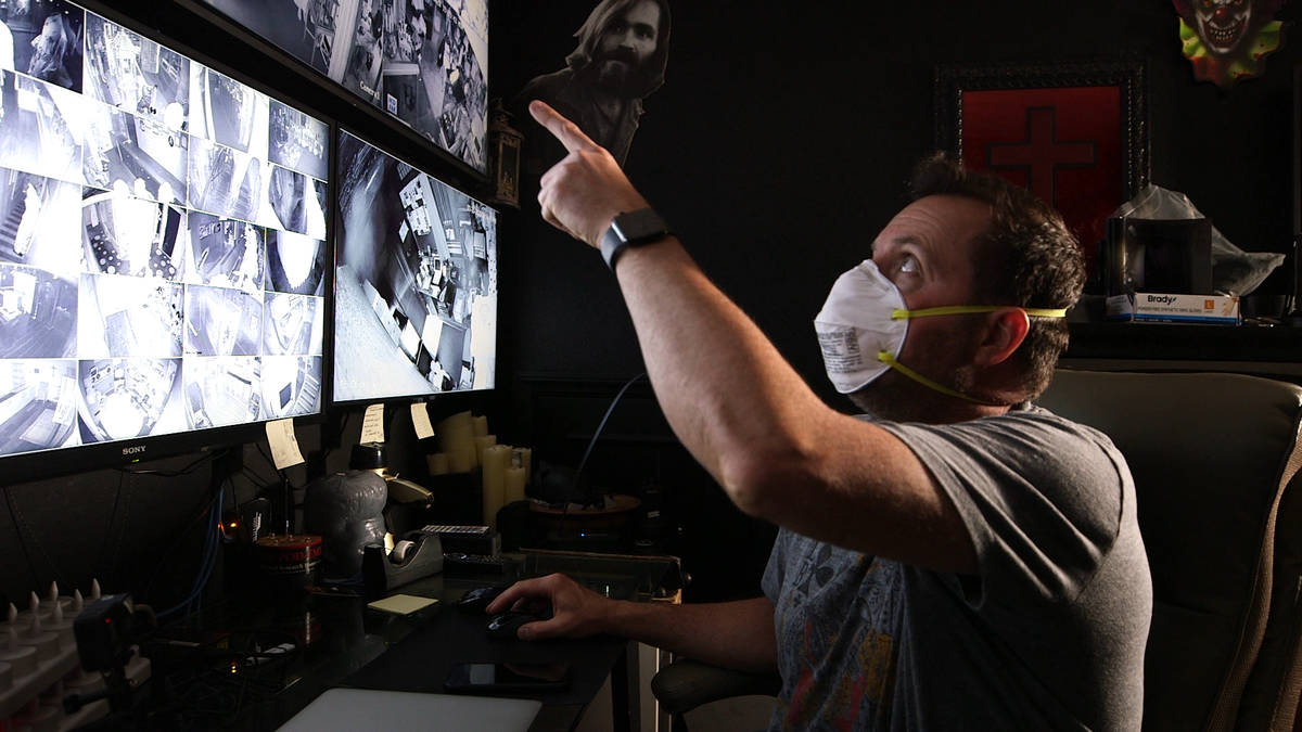 Billy Tolley looks at video footage during the production of "Ghost Adventures: Quarantine." (T ...