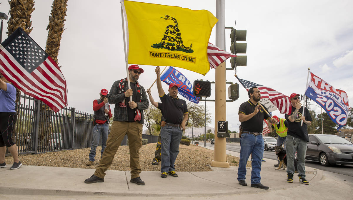Proud Boys welcome all to enter as Reopen Nevada holds a protest at the Grant Sawyer State Offi ...