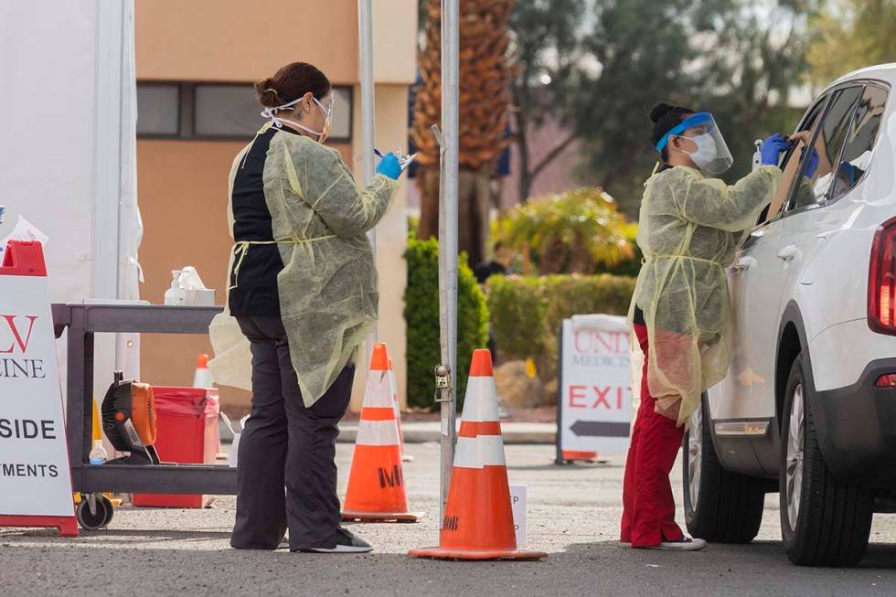 UNLV medicine medical professionals conduct a curbside test on a patient experiencing coronavir ...