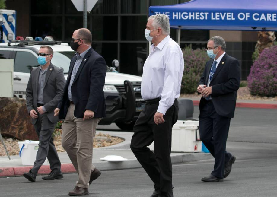 Gov. Steve Sisolak, center, leaves University Medial Center on Tuesday, June 2, 2020 after visi ...