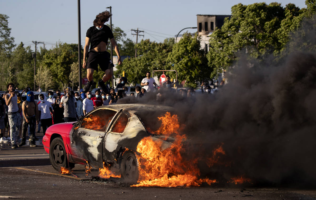 A car burns in a Target parking lot Thursday, May 28, 2020, in Minneapolis. Minnesota Gov. Tim ...