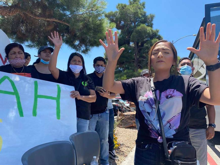 Melissa Diaz holds her hands to the sky in prayer for Las Vegas officer Shay Mikalonis in front ...