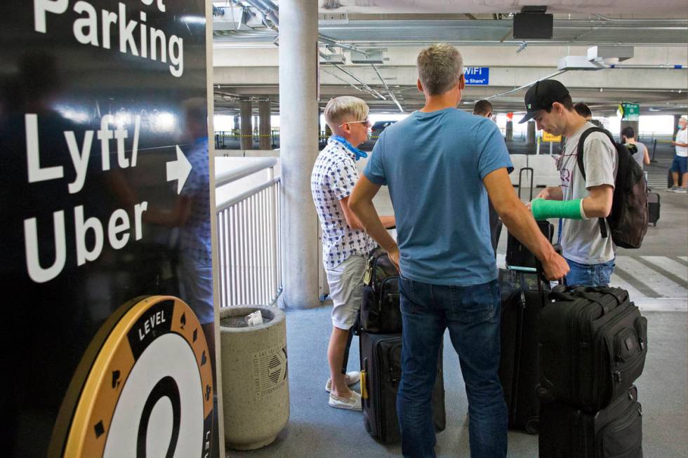 Arriving passengers wait for their ride at ride share waiting area at McCarran International Ai ...