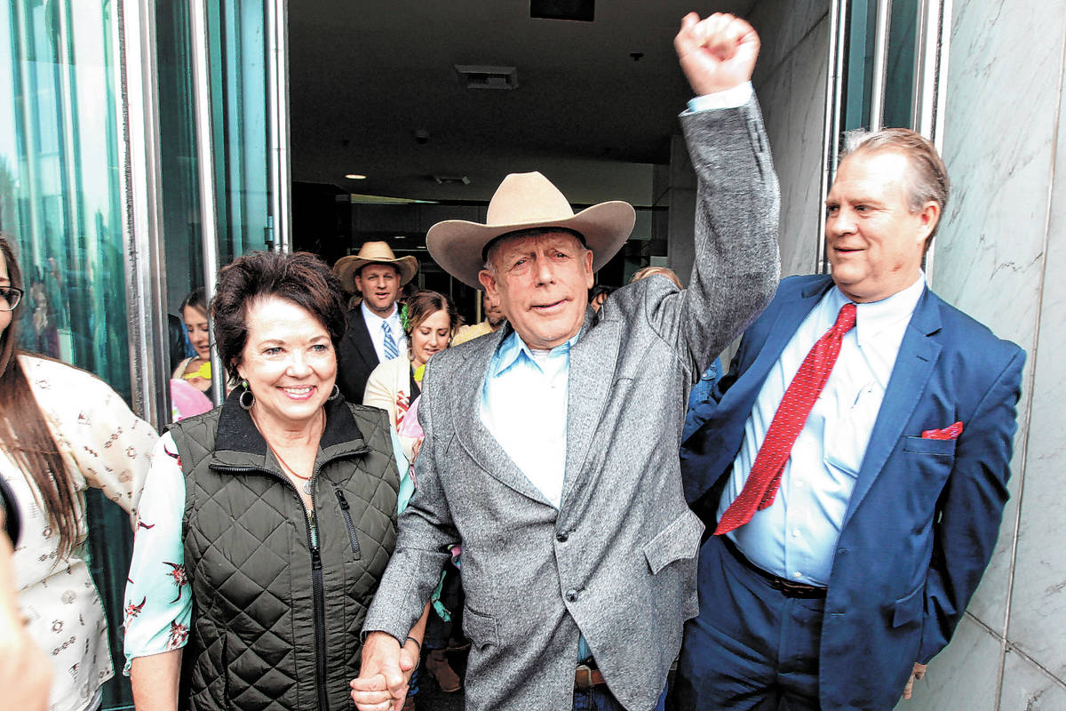 Cliven Bundy walks out of Lloyd George U.S. Courthouse in Las Vegas a free man with his wife Ca ...