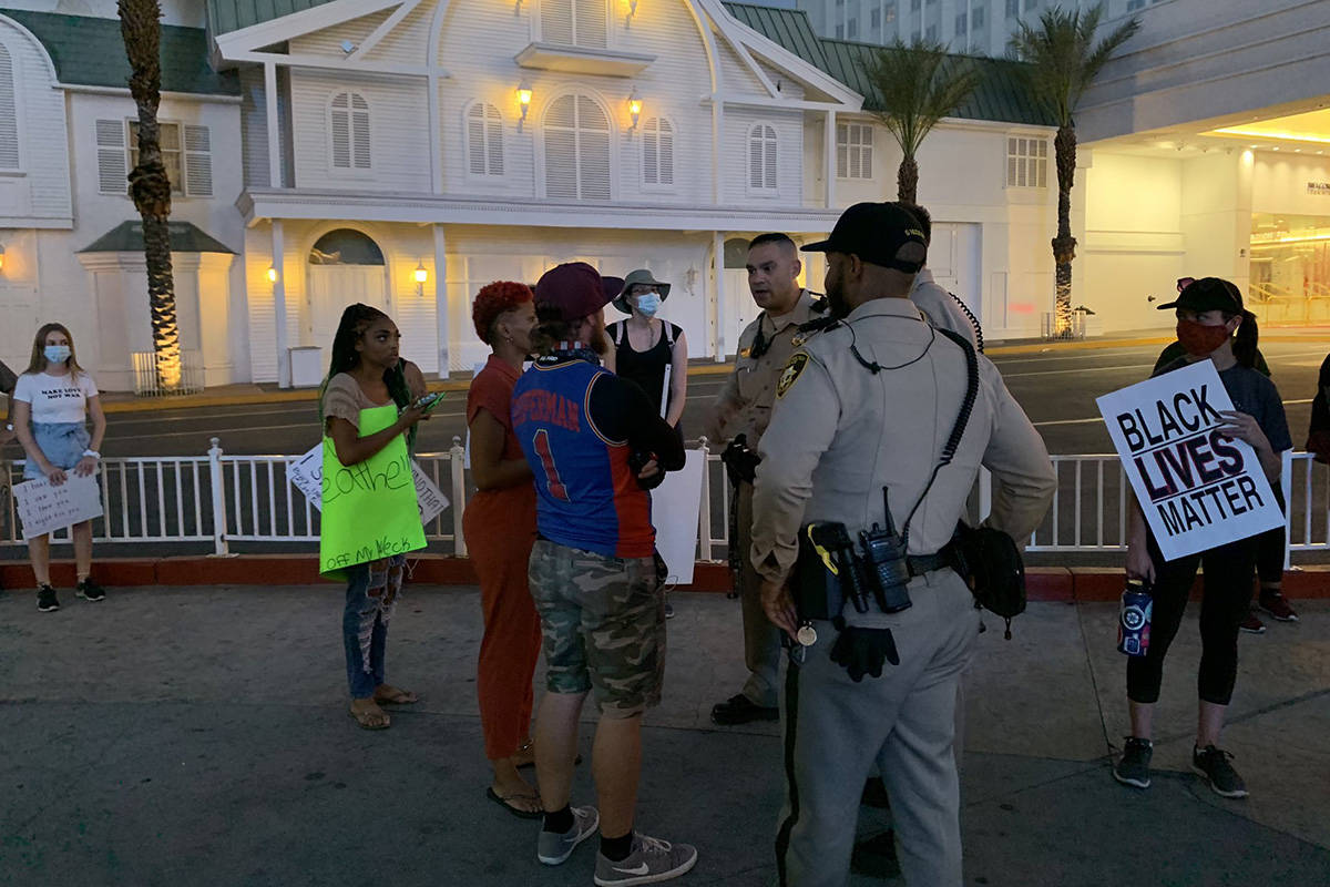 Las Vegas police and protesters meet before a march on the Las Vegas Strip on Thursday, June 4, ...