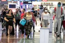 Arriving passengers head toward a baggage claim area at McCarran International Airport on Thurs ...